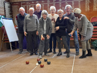 A group of bowlers playing carpet bowls