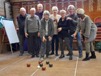 A group of bowlers playing carpet bowls