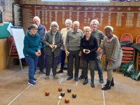 A group of bowlers playing carpet bowls