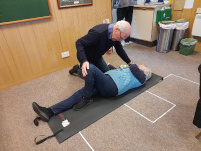 Man doing CPR on a volunteer