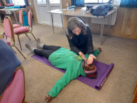 Woman doing CPR on a volunteer