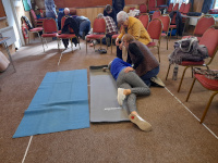 Woman doing CPR on a volunteer