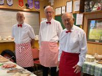 Three men serving lunch